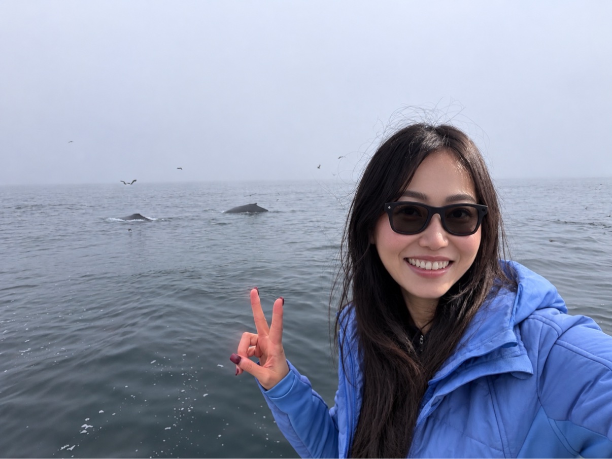 Selfie with two humpback whales surfacing in the background, Monterey Bay